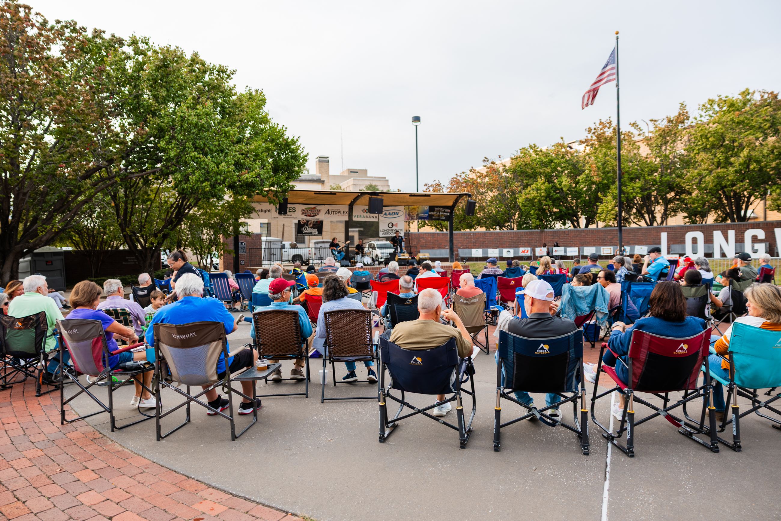 Downtown Live audience at Heritage Plaza with American flag and Longview letters in background